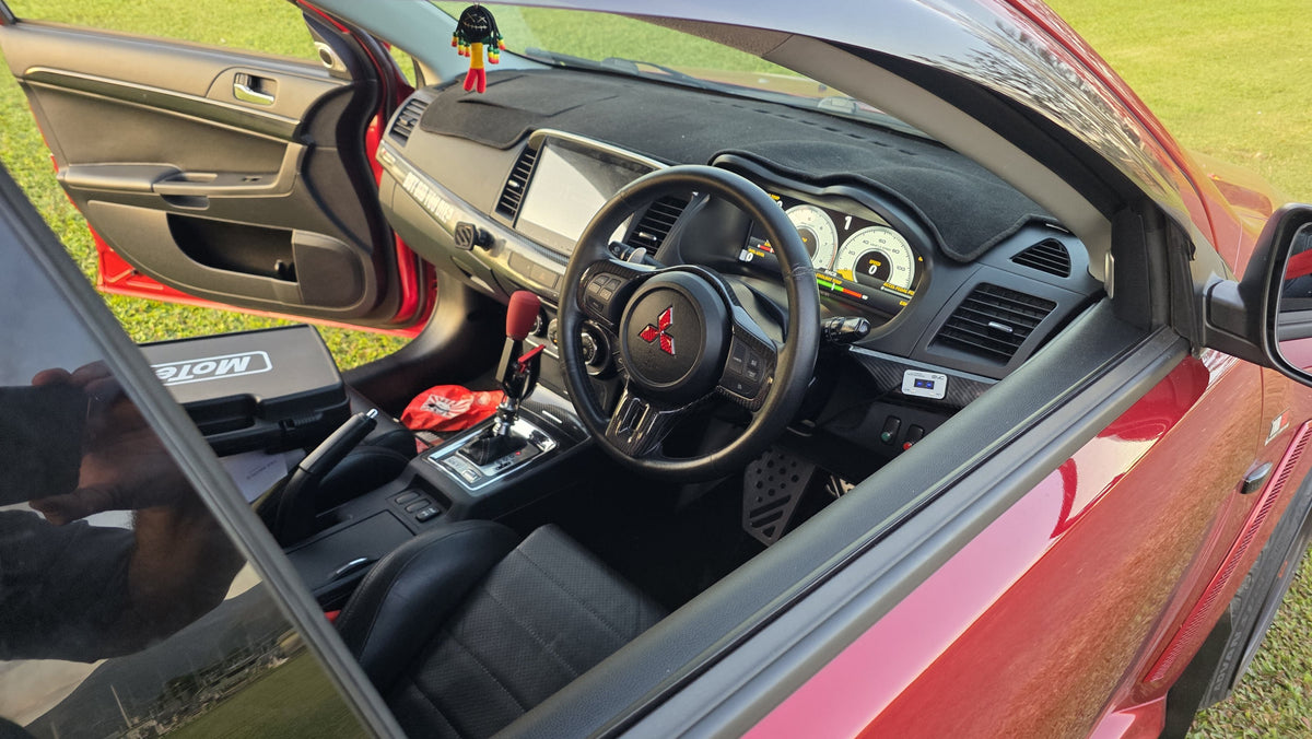 Digital dash cluster mount installed in a red Mitsubishi Lancer Evolution X